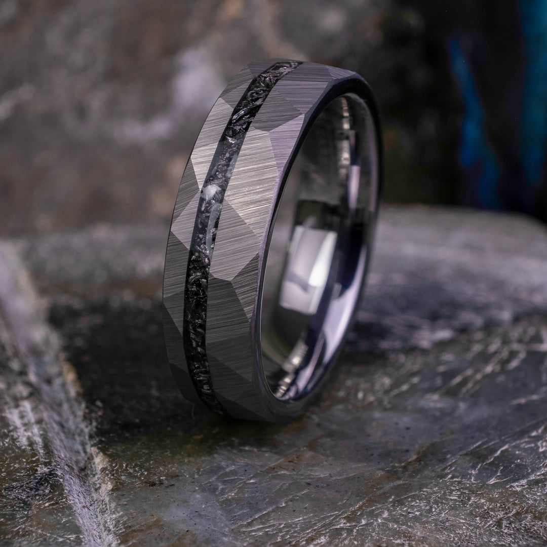 6mm silver hammered tungsten carbide wedding band with a crushed meteorite stripe,  on top a large grey stone. 