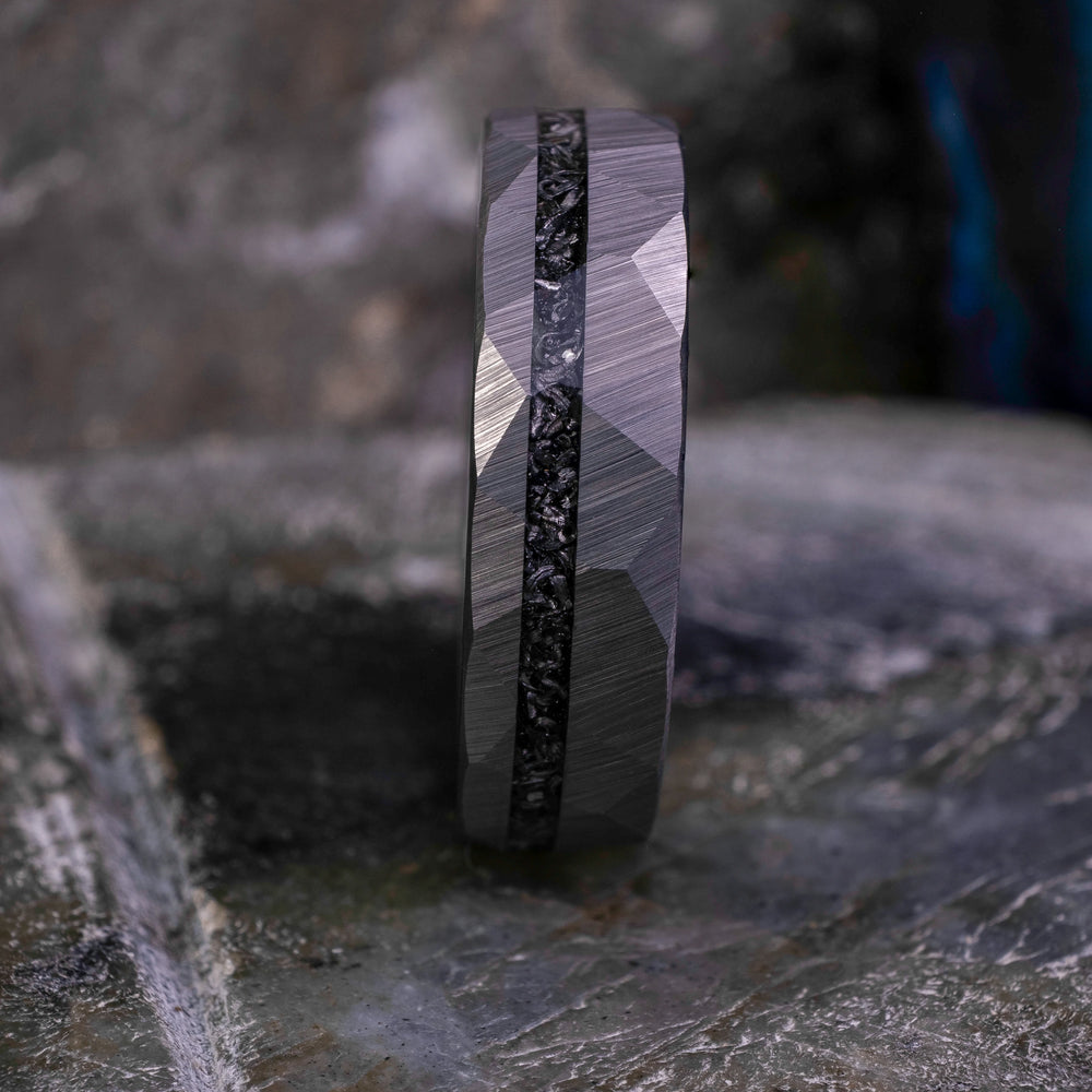 6mm silver hammered tungsten carbide wedding band with a crushed meteorite stripe,  on top a large grey stone. 