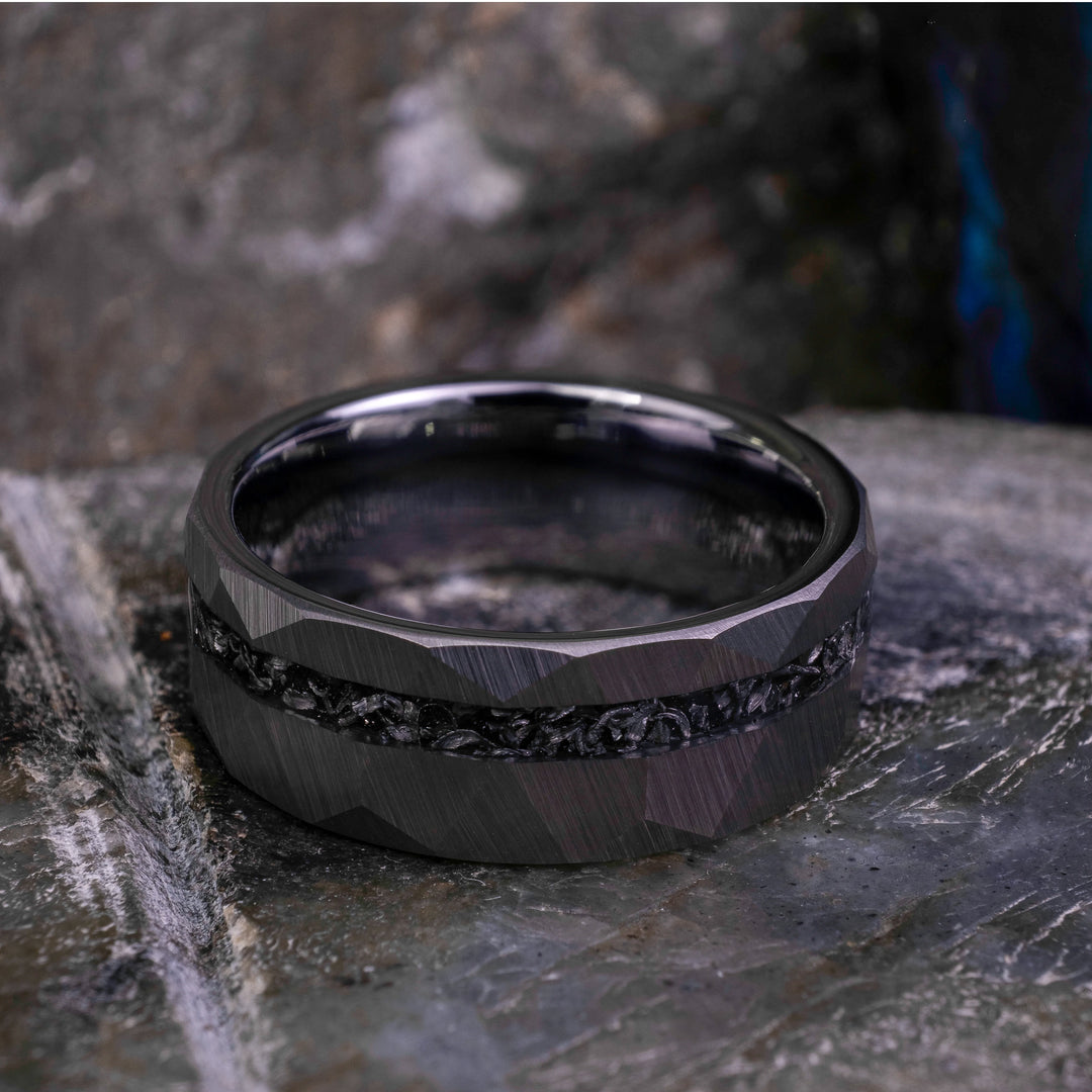 8mm silver hammered tungsten carbide wedding band with a crushed meteorite stripe,  on top a large grey stone. 
