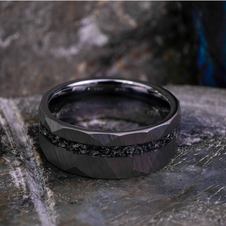 8mm silver hammered tungsten carbide wedding band with a crushed meteorite stripe,  on top a large grey stone. 