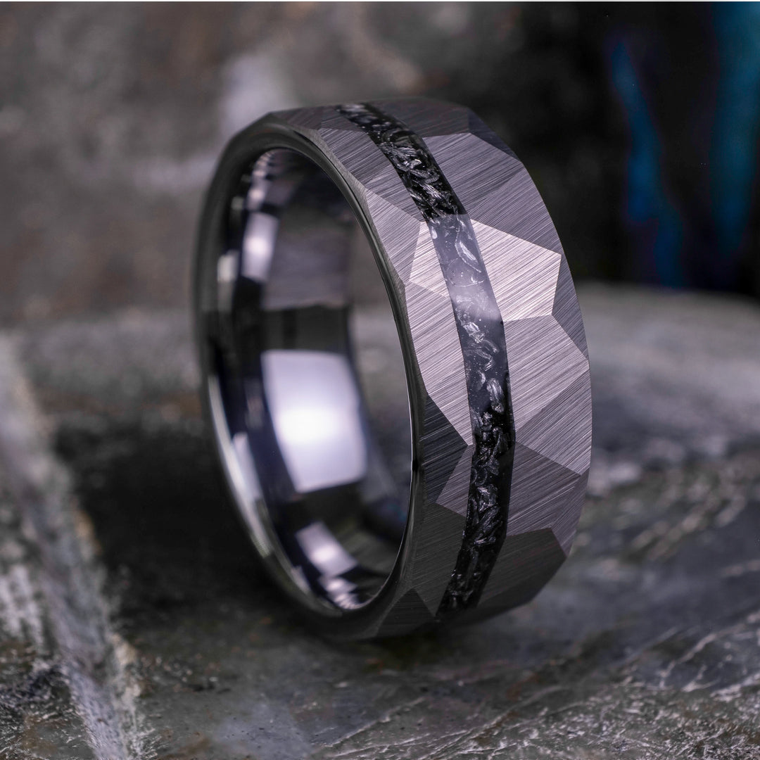 8mm silver hammered tungsten carbide wedding band with a crushed meteorite stripe,  on top a large grey stone. 