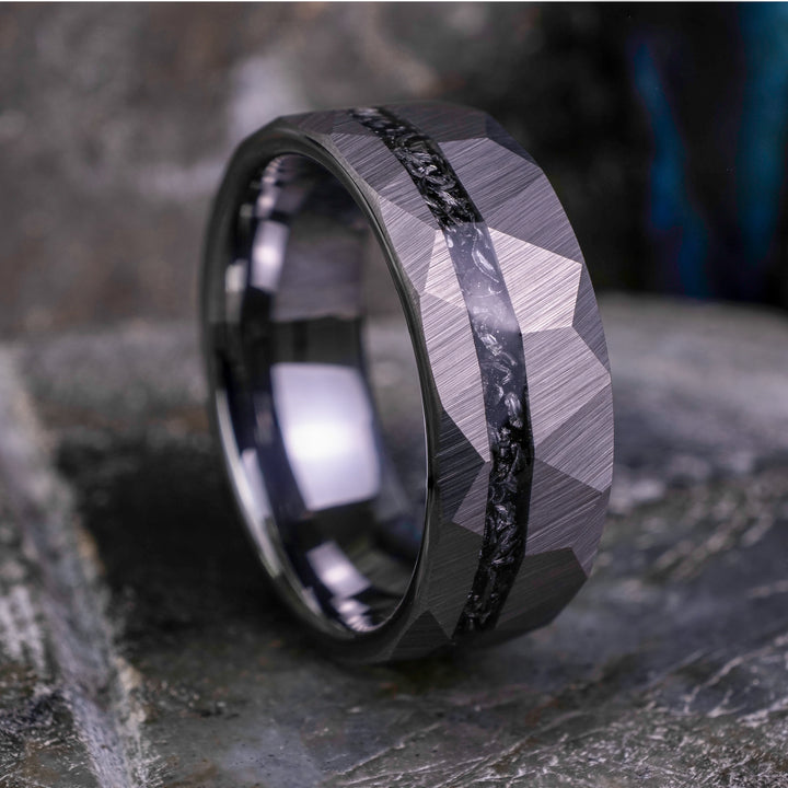 8mm silver hammered tungsten carbide wedding band with a crushed meteorite stripe,  on top a large grey stone. 