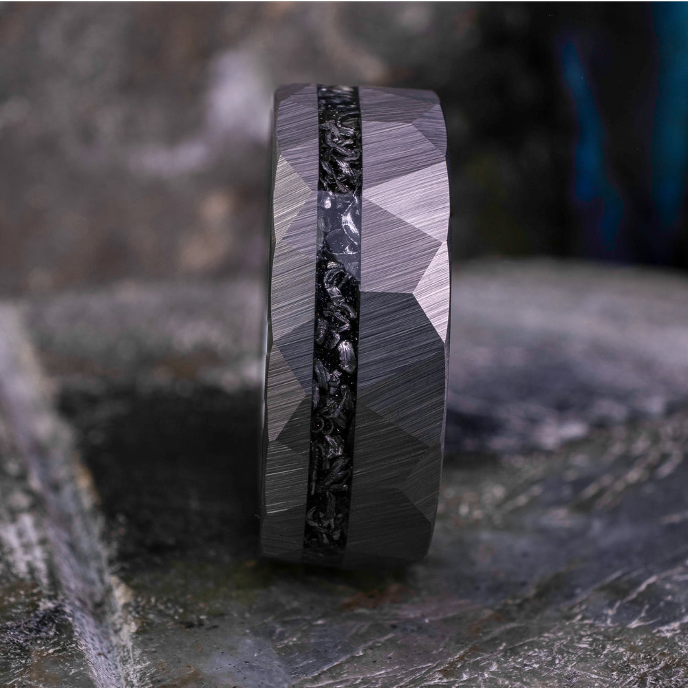 8mm silver hammered tungsten carbide wedding band with a crushed meteorite stripe,  on top a large grey stone. 