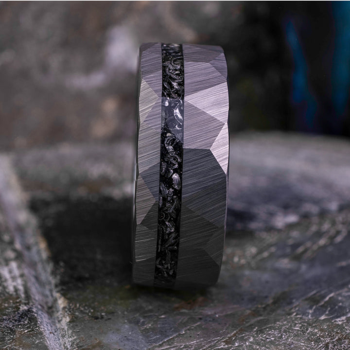 8mm silver hammered tungsten carbide wedding band with a crushed meteorite stripe,  on top a large grey stone. 