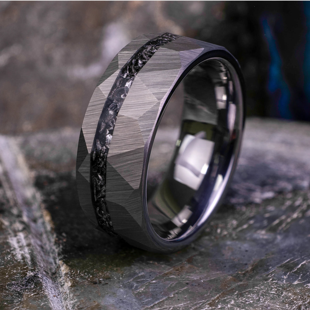 8mm silver hammered tungsten carbide wedding band with a crushed meteorite stripe,  on top a large grey stone. 