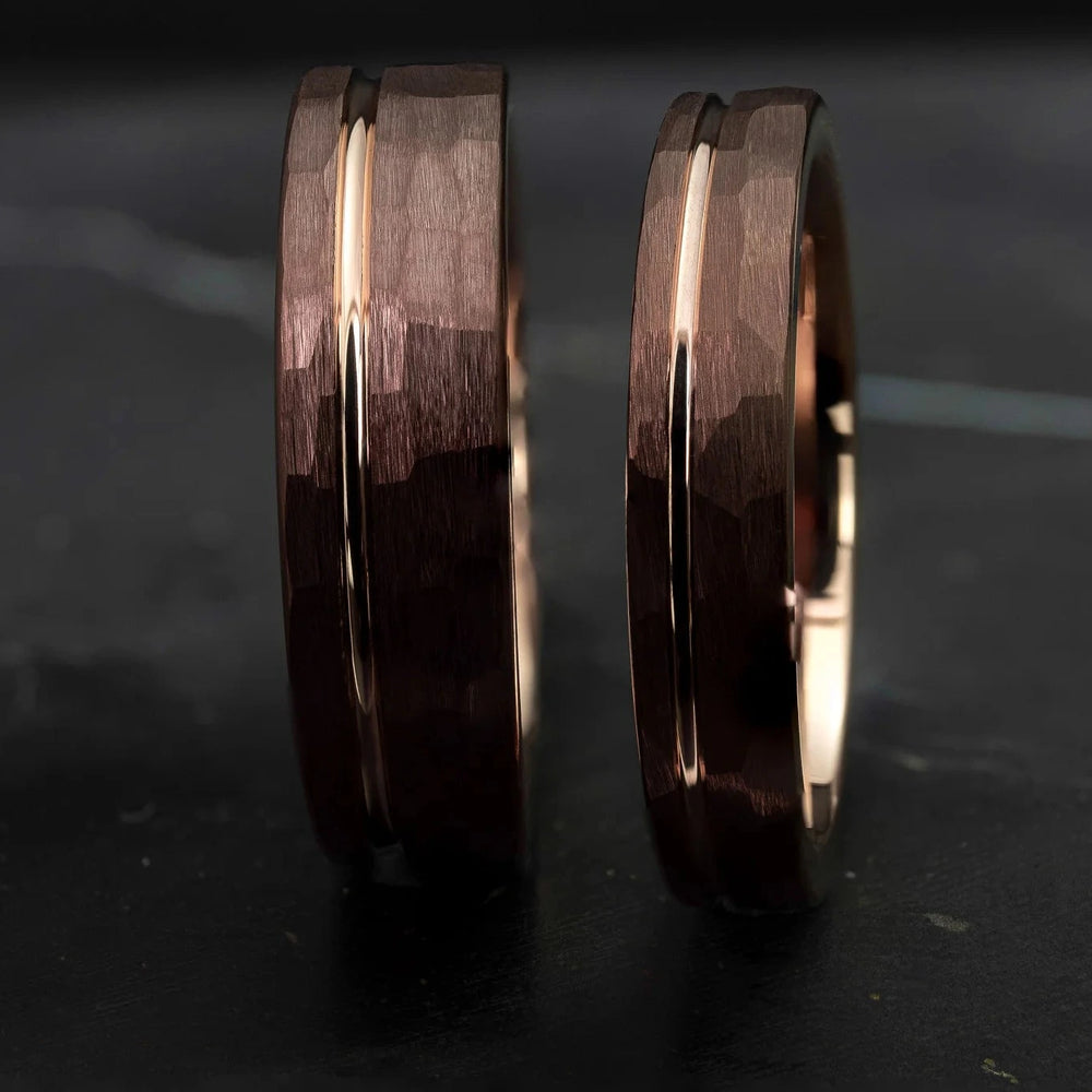 Hammered His and Hers mocha brown with a stripe and rose gold interior, on top of a dark stone.