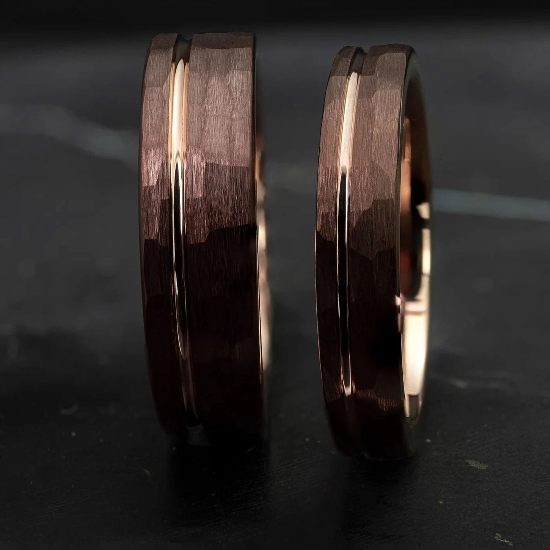 Hammered His and Hers mocha brown with a stripe and rose gold interior, on top of a dark stone.