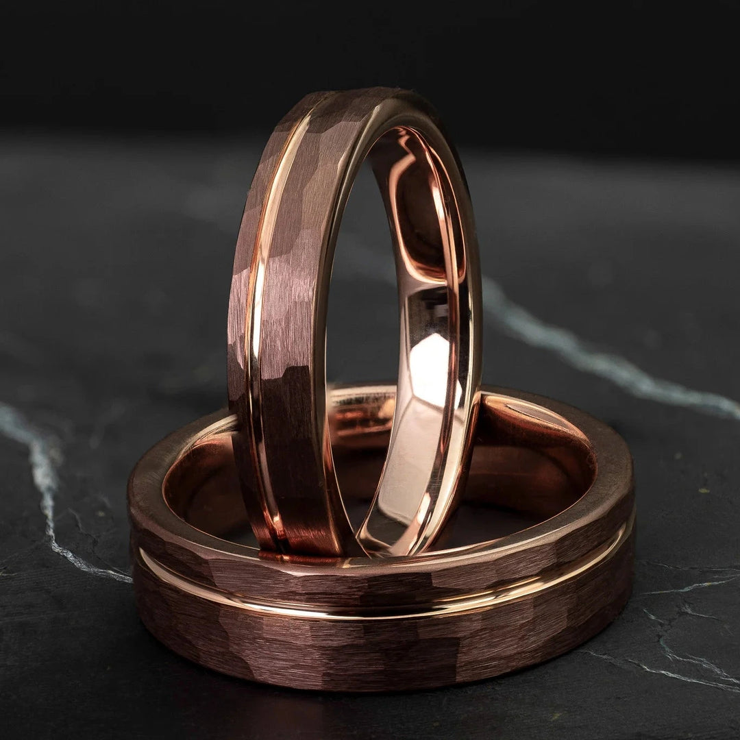 Hammered His and Hers mocha brown with a stripe and rose gold interior, on top of a dark stone.