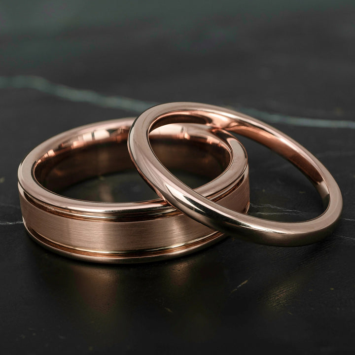 His and hers polished rose gold wedding bands in 2mm and 6mm widths, featuring a smooth high shine finish and matching minimalist design.